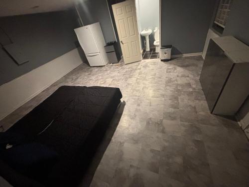 a living room with a couch and a refrigerator at Delightful Studio, 15 mins to Downtown Atlanta in Salem West