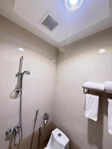a bathroom with a shower and a toilet at 92 - وحدات فندقية - in Unayzah