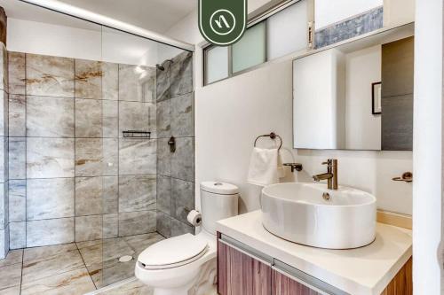 a bathroom with a sink and a toilet and a shower at 3 BR Condo - Panoramic Views - 5 Min to Downtown in Oaxaca City