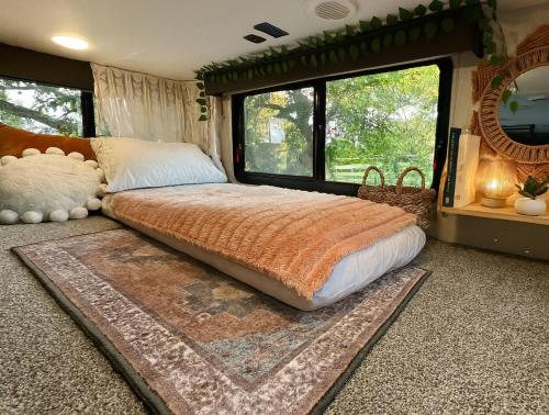 a bedroom with a bed and a large window at The Loft | Creekside in Mansfield