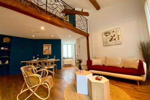 a living room with a couch and a table at The Montpellier Escape-Duplex featuring a terraceconditioning in Montpellier