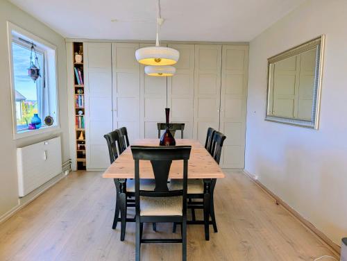 a dining room with a wooden table and chairs at Comfy room - Ski center - near Ås - 11 min to Oslo in Ski