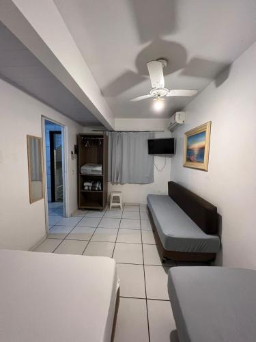 a living room with a couch and a tv at Dubai in Balneário Camboriú