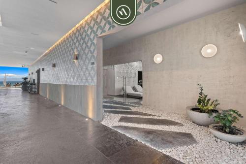 a lobby of a house with plants on the floor at Luxury 2 BR Condo with Dream Pools - Beach - Art in Bucerías