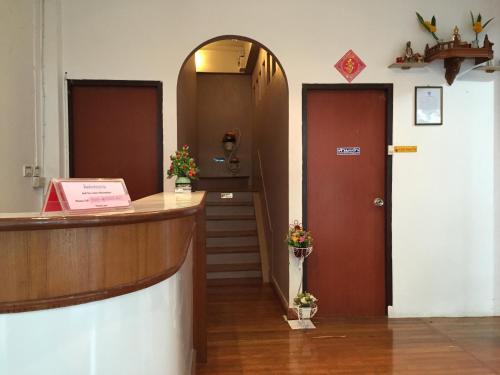 a lobby with two doors and a hallway with stairs at Nawaporn Place in Phuket Town
