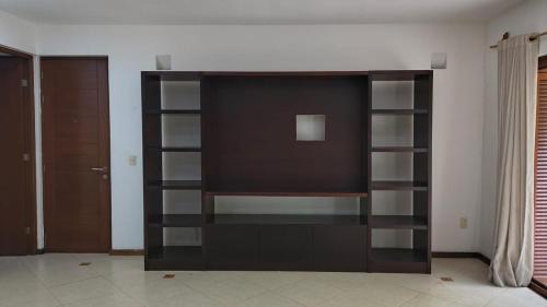 a black book shelf in a living room at Selvamar 402 in Playa del Carmen