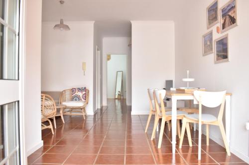a dining room with a table and chairs at Abrigo das Matas in Porto Santo