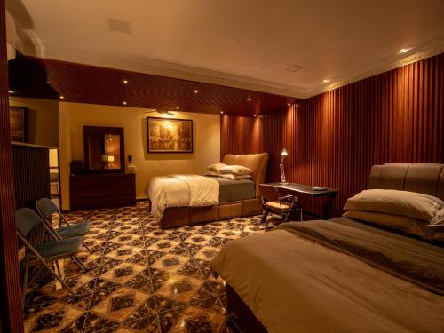 a hotel room with two beds and a desk at Cozy-SJ-Family Holidays-Work-BBQ-Tea ceremony-Engagement in Subang Jaya