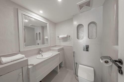 a white bathroom with a sink and a mirror at Mabaat-Jasmine Greek Villa 4BR- 583 Villa 16 in Jeddah