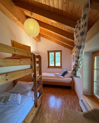 a room with two bunk beds and a chandelier at Charming ski-in ski-out mountain hut in Lenzerheide
