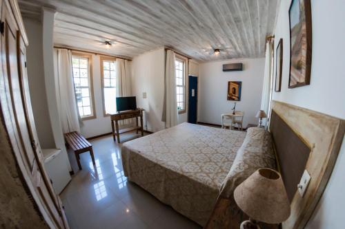 Ένα ή περισσότερα κρεβάτια σε δωμάτιο στο Ville Real Hotel