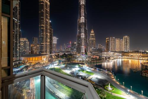 a view of a city skyline at night at GuestReady - Charming stay with Burj Khalifa views in Dubai