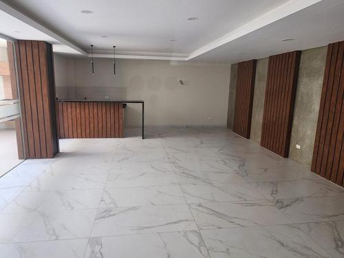 an empty room with a marble floor and a table at new apartment in Cochabamba
