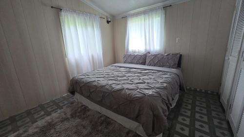 a bedroom with a large bed in a room at Nestled Vacation Home in Saint Johnʼs