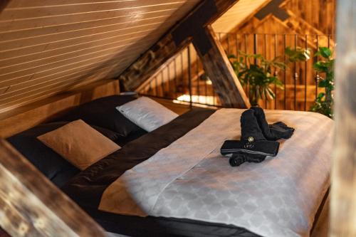 a large bed in the attic of a house at Wellnes Hříbek in Dyjákovice