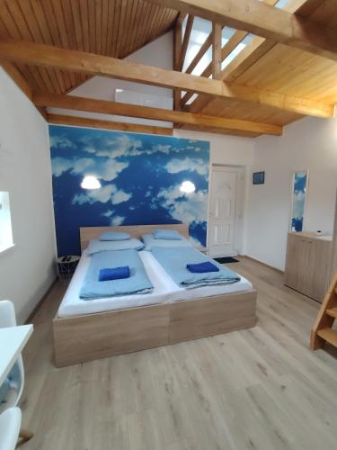 a bedroom with a large bed in a room at Csengő Vendégház in Kiskőrös