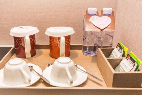 a shelf with two jars of honey and plates and a box at Guangzhou CHILLNOW Hotel in Guangzhou