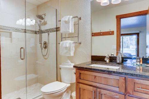 a bathroom with a shower and a toilet and a sink at 3 Spyglass in Sunriver