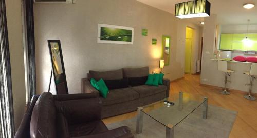 a living room with a couch and a glass table at Vip apartment Beograd in Belgrade