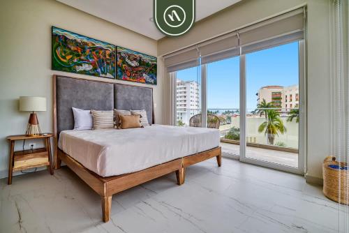 a bedroom with a large bed and a large window at New 2 BR Condo One Street From Beach - Pool - Gym in Nuevo Nayarit