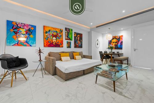 a living room with a bed and a table at Amazing 1 BR Condo in Romantic Zone - Pool - Gym in Puerto Vallarta