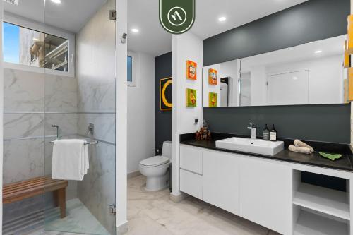 a bathroom with a sink and a toilet at Amazing 1 BR Condo in Romantic Zone - Pool - Gym in Puerto Vallarta