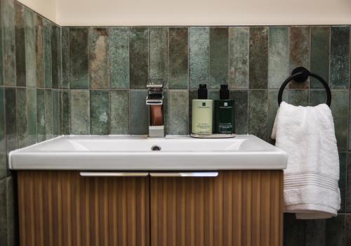 a bathroom with a sink and a towel at Neddy Meadow in Grinton