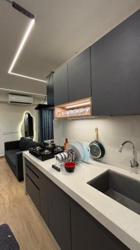 a kitchen with a sink and a counter top at Studio at walking distance from airport in Pune