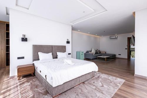 a bedroom with a large bed and a living room at Villa Indigo in Rabat