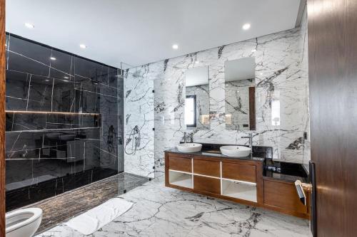 a bathroom with two sinks and a shower at Villa Indigo in Rabat