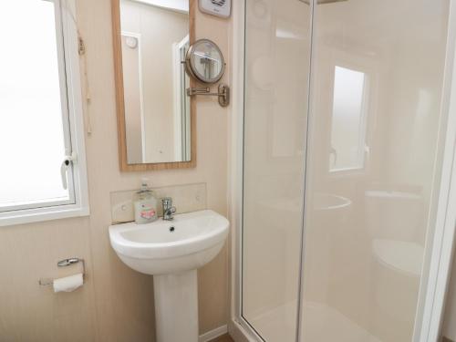 a bathroom with a sink and a shower at Peaceful in Portpatrick