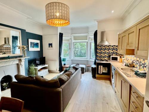a living room with a couch and a kitchen at St Helens House in Portsmouth