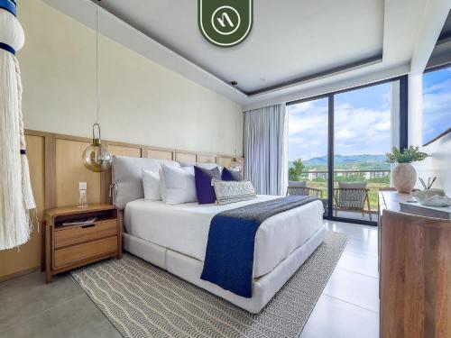 a bedroom with a large bed and a large window at Luxury Oceanfront 3 BR Condo with Balcony in Cruz de Huanacaxtle