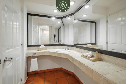 a bathroom with a sink and a large mirror at Amazing 2 BR Condo - Private Terrace - Pool in Puerto Vallarta