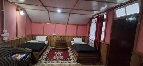 a small room with two beds and a window at Welcome homestay in Pemayangtse