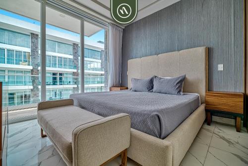 a bedroom with a large bed and a large window at 2BR Condo with Private Balcony - Padel Court in Nuevo Nayarit