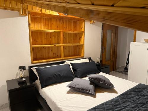 a bedroom with a bed with two pillows on it at Stone Nest Lanzada in Lanzada
