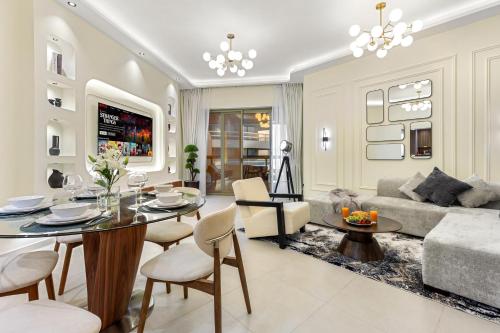 a living room with a table and a couch at Desert Key Luxury Apt with Seaview, Saadiyat Island in Abu Dhabi
