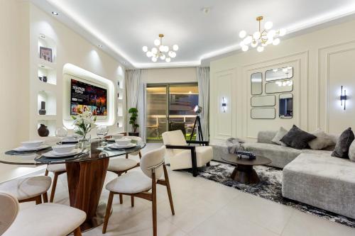 a living room with a table and a couch at Desert Key Luxury Apt with Seaview, Saadiyat Island in Abu Dhabi