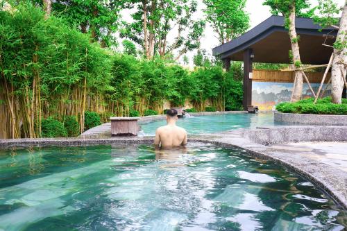 a man in a swimming pool at a resort at Căn hộ khách sạn wyndham Thanh Thuỷ in La Phu