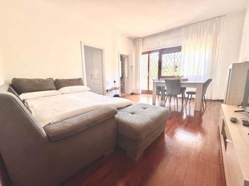 a bedroom with a bed and a dining room with a table at Martina's Nest in Rome