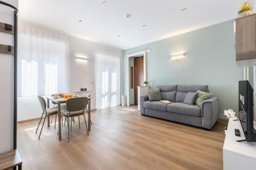 a living room with a couch and a table at NEW Luxury Flat 10min P Nuova in Turin