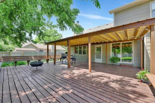 a wooden deck with a pavilion on a house at Backyard Bliss in Wichita