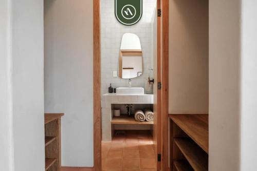 a bathroom with a sink and a mirror at Centric 3BR Condo in Downtown in Oaxaca in Oaxaca City