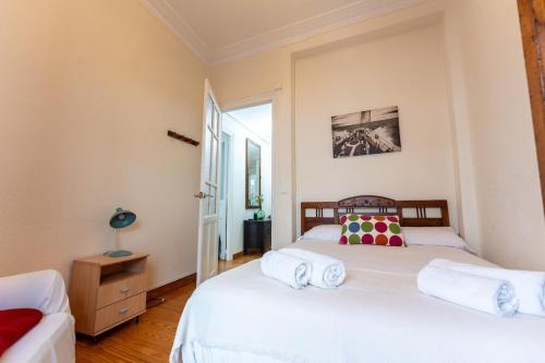 a bedroom with two beds and a window at Tu refugio luminoso en el corazón de Santander in Santander