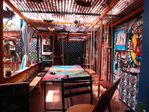 a dining room with a table and a wall with paintings at Jabulani Nairobi Backpackers Hostel in Nairobi
