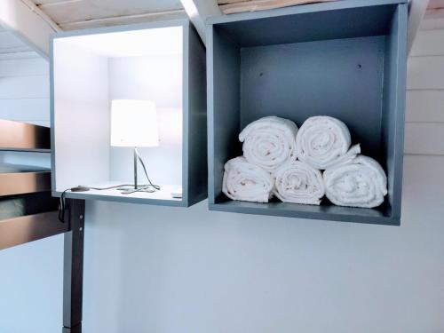 a box filled with white towels in a room at Downtown Beach Retreat in Luquillo