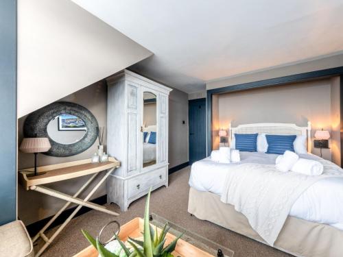 Un dormitorio con una gran cama blanca y un espejo. en 3 Bed in Portpatrick 77308, en Portpatrick