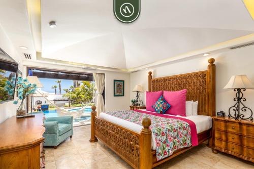a bedroom with a bed and a desk and a window at Amazing Villa with 3BR - Private Pool in El Tule