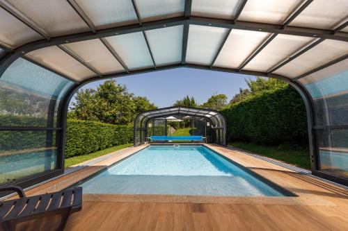 an indoor pool in a house with an archway at Quintinha da Cachadinha in Ponte de Lima